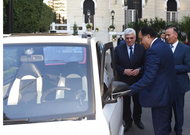 وزير التعليم العالي مع رئيس الوزراء خلال استعراضه نماذج للسيارات الكهربائية المصرية